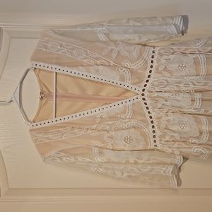 NWOT lace deep v-neck line with eye hook closure. Soft white lace over nude